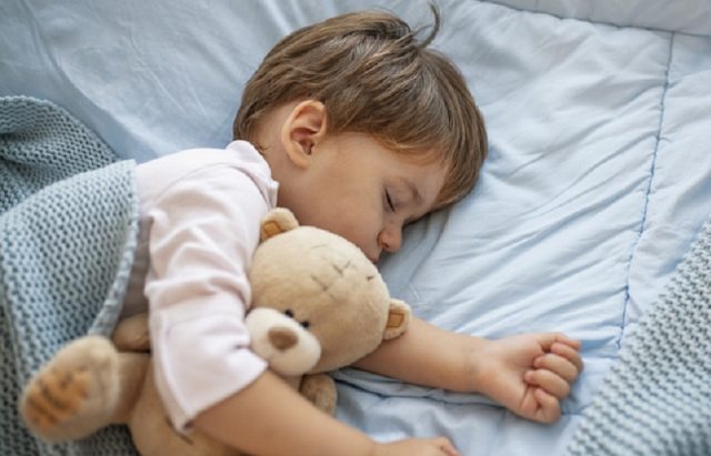 Cute little kid sleeping. Little boy sleeping in bed Cute little boy sleeping, tired child taking a nap in his small bed, clean, fresh and cozy bedding sheets, bedtime for kids